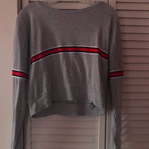 grey long sleeve crop top with red stripe